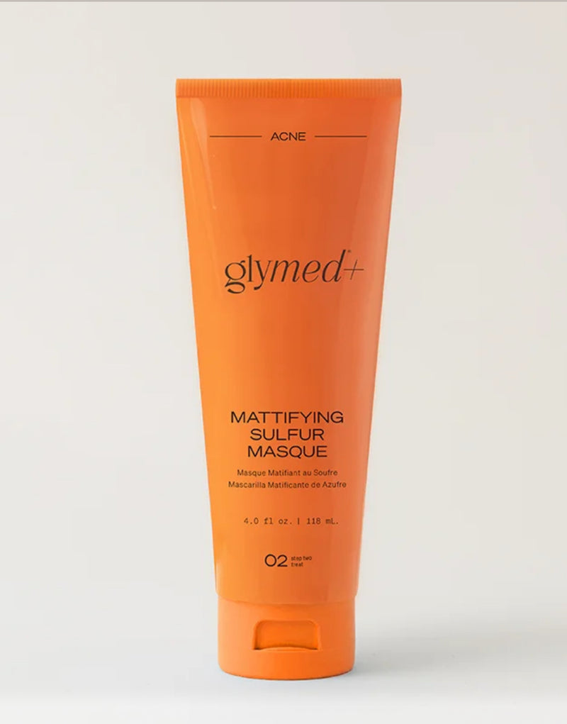 Orange tube of Glymed Mattifying Sulfur Masque on a light gray background